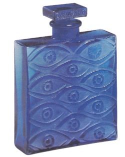 blue rectangular bottle with eyes carved into it