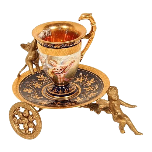 teacup of tea being pulled on a saucer sitting on a small chariot of gold