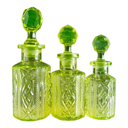 three uranium glass bottles