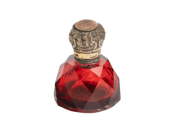 small bottle with a large cork and red liquid inside