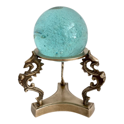 teal orb in an ornate brass holder
